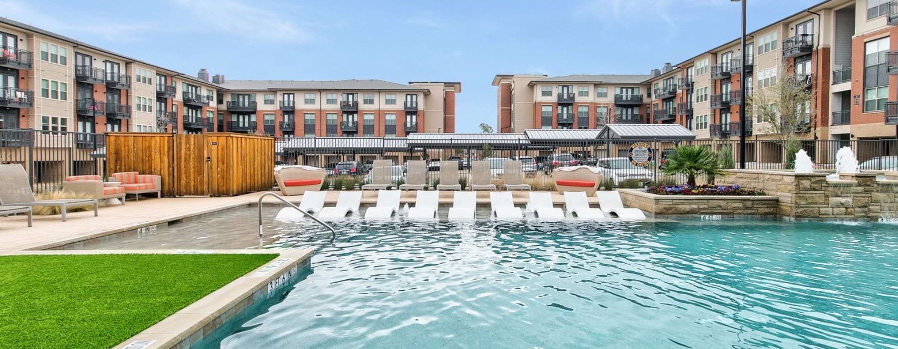 a swimming pool with lounge chairs