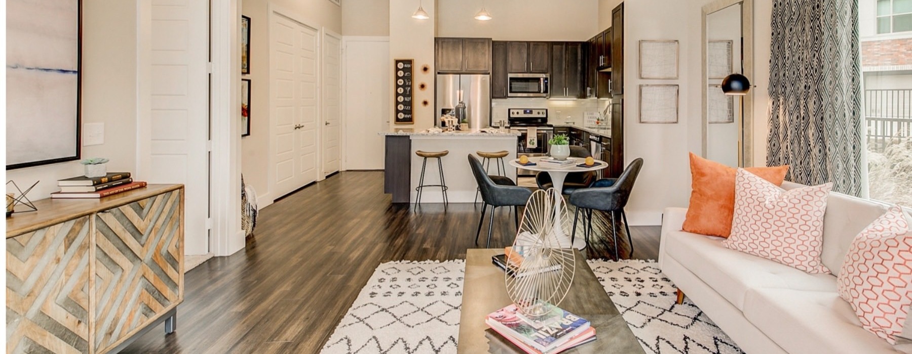 a living room with a couch, tables and chairs